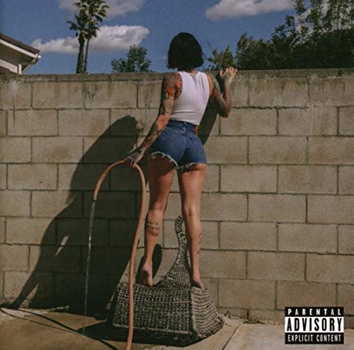 Kehlani album cover: woman facing a brick wall, denim shorts.