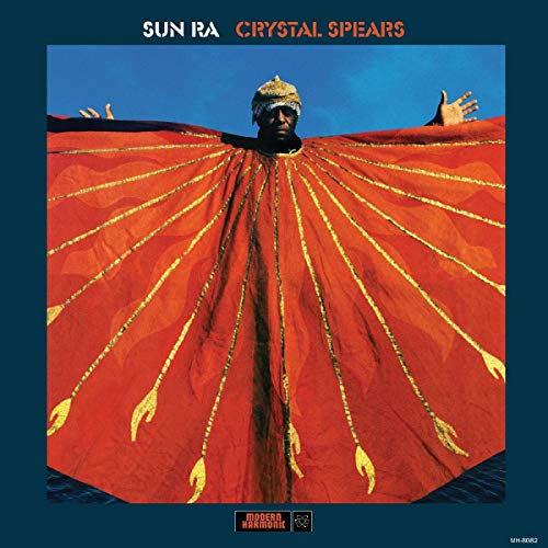 Sun Ra in ornate gold headdress and red, radiating cape.