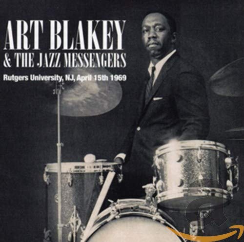 Art Blakey portrait in front of a drum kit, album cover art.