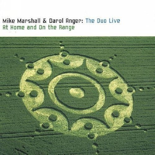 CD cover featuring a crop circle pattern in a green field with album text.