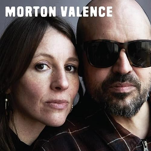 Close-up portrait of two people, a woman and a man with sunglasses.