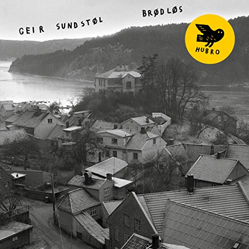 Black and white CD cover with a landscape and yellow bird logo.