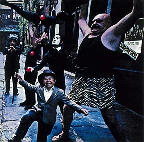 The Doors’ “Strange Days” album cover featuring performers in a street scene.
