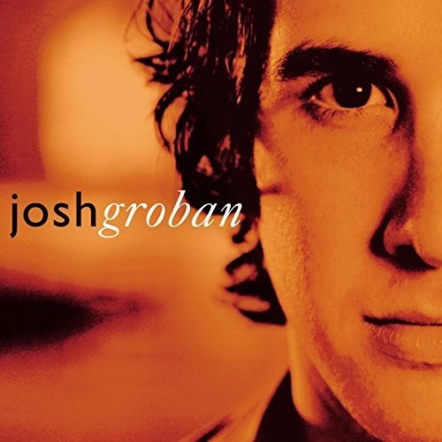 Close-up portrait of Josh Groban on an orange album cover.