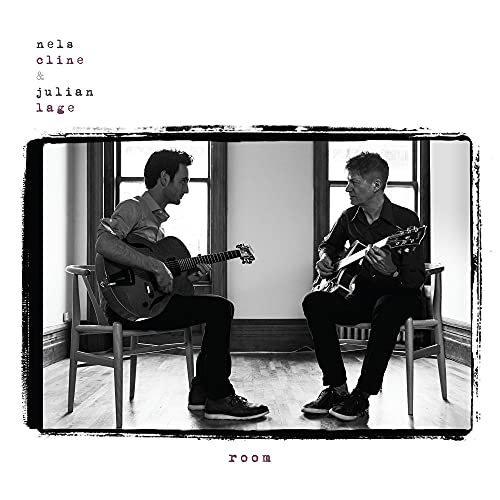 Black and white album cover featuring two guitarists seated by a window.