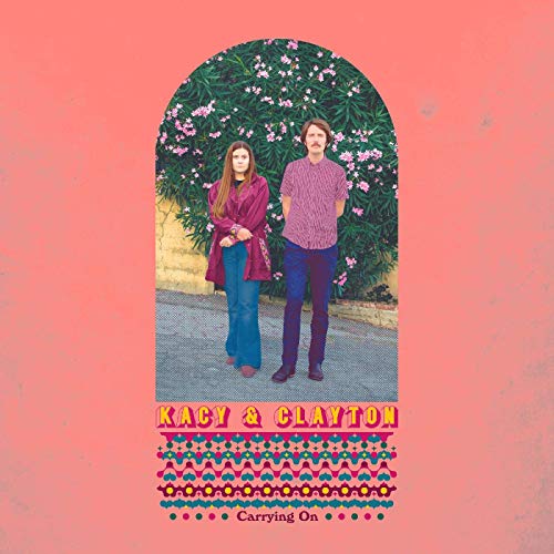 Album cover for Kacy & Clayton’s “Carrying On” featuring a couple in front of flowers.