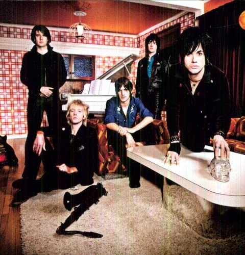 Prima Donna band portrait in a retro-styled room, album cover art.