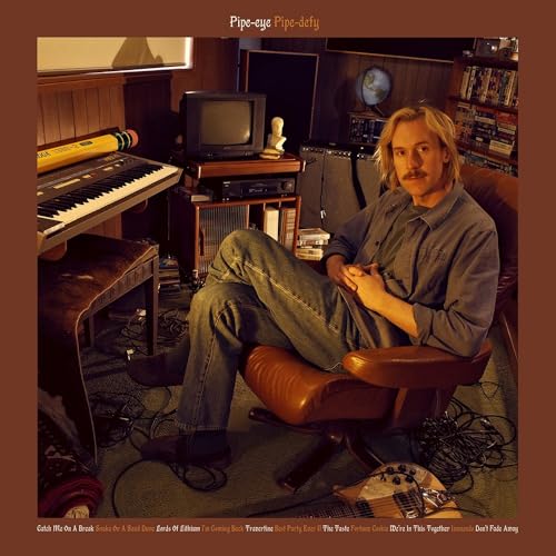 Vinyl album cover featuring a man with a keyboard in a room.