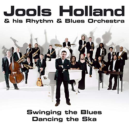 Jools Holland and his orchestra in suits, with piano and instruments.