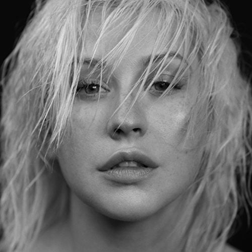 Black and white close-up portrait of Christina Aguilera with wet hair.