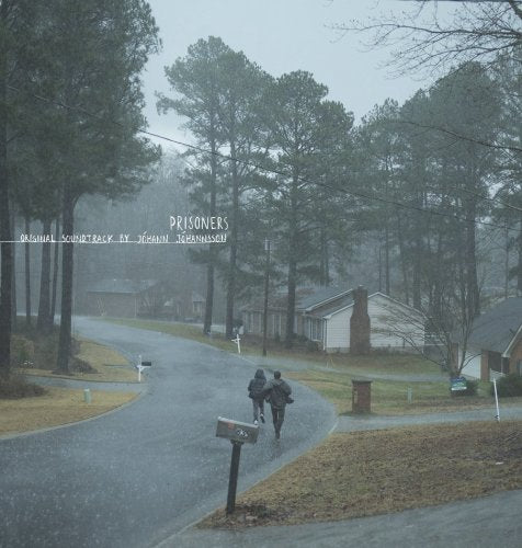 Prisoners" soundtrack vinyl cover: rainy suburban street, two figures walking.