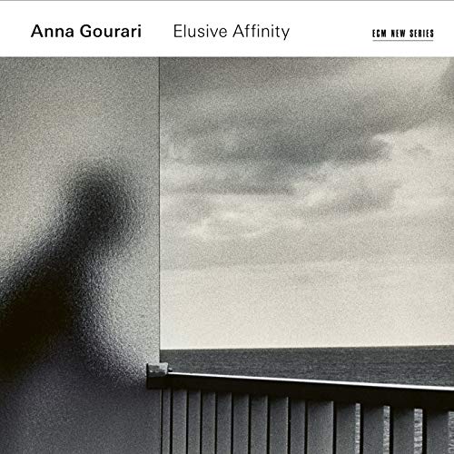 CD cover: blurry figure by a window overlooking the sea.