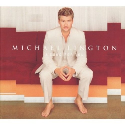 CD cover featuring Michael Lington in a light suit, seated barefoot.