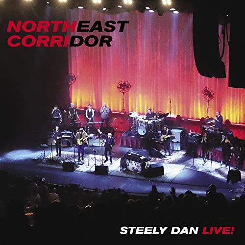 Steely Dan live concert album cover with band on stage, red curtain.