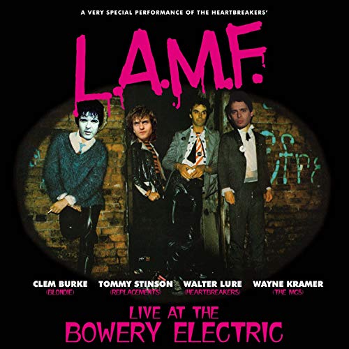 CD cover featuring four musicians standing in front of a graffiti wall.