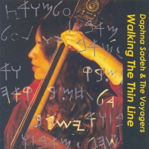 CD cover: woman playing a cello with abstract writing overlay.