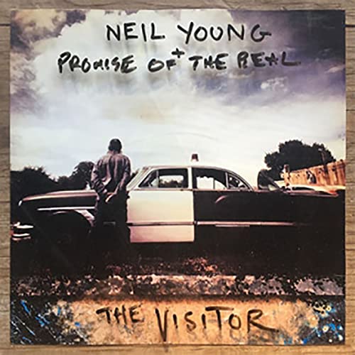 Album cover for Neil Young’s “The Visitor” featuring a man and cars.