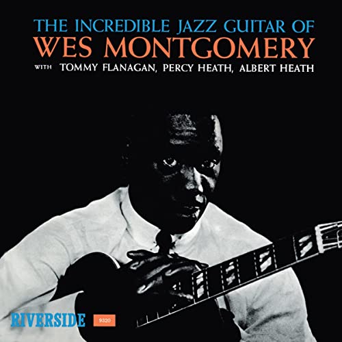 Wes Montgomery album cover, black background, man playing guitar.