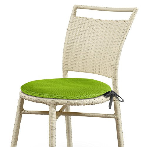 Wicker chair with a bright green cushioned seat, viewed from the side.