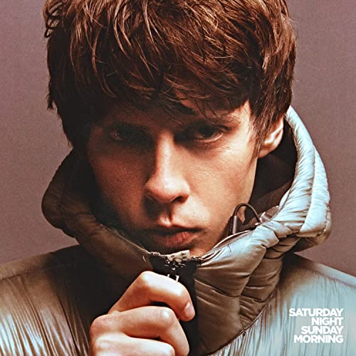 Jake Bugg album cover, close-up portrait of a young man in a puffer jacket.