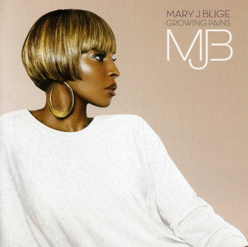 Mary J. Blige in a white shirt with blonde bob hair and large earrings.