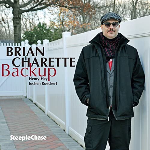 Album cover for Brian Charette’s “Backup” featuring a man in a cap and jacket.