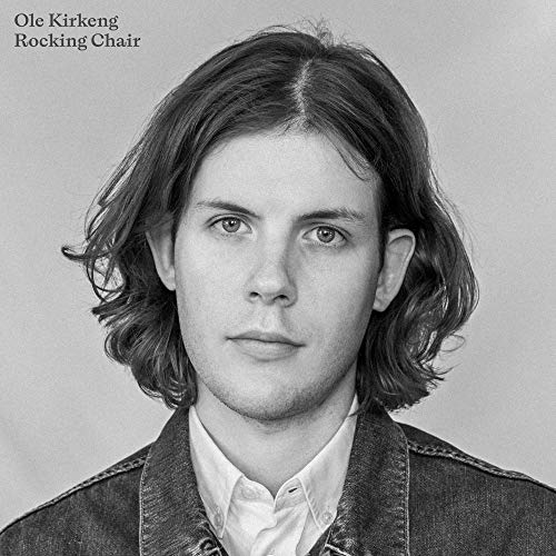Black and white portrait of a young man with wavy hair.
