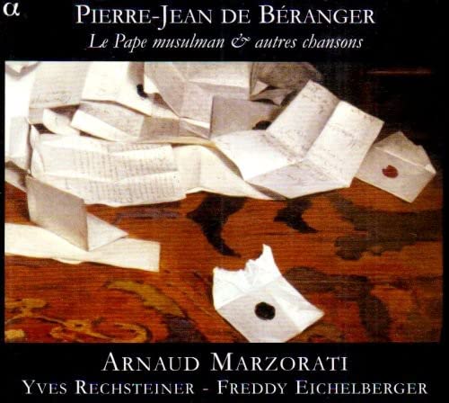 CD cover with scattered papers and handwritten text on a wood surface.
