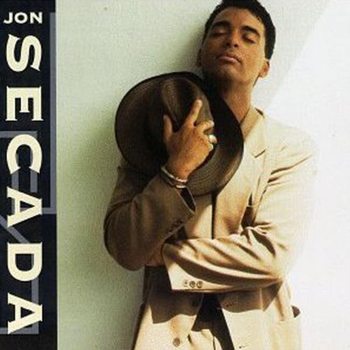 Jon Secada album cover: man in a suit holding a hat.