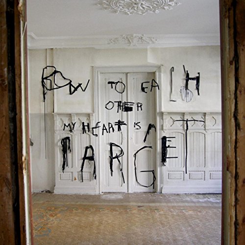 Graffiti text on white doors in a decaying, ornate room.