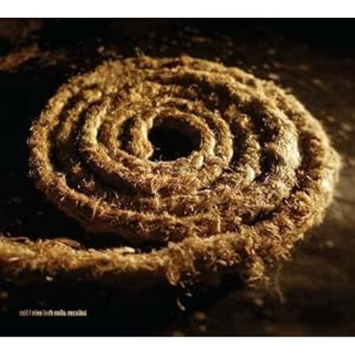 Spiral of rough, brown fiber against a dark background.