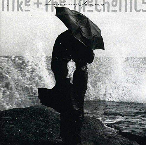 Black and white CD cover: figures with umbrella by the sea.