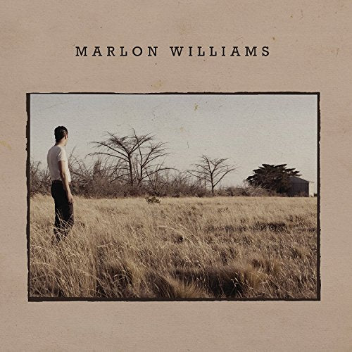 Album cover: man standing in a field with sparse trees.