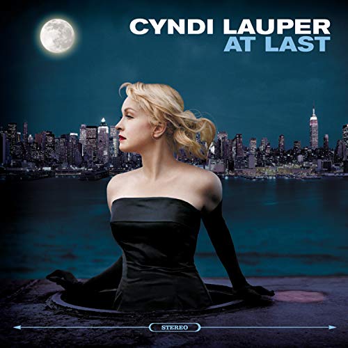 Cyndi Lauper album cover, "At Last," with a city skyline backdrop.