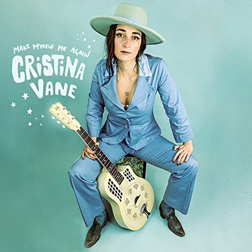 Cristina Vane album cover: woman with guitar, wearing a blue suit and hat.