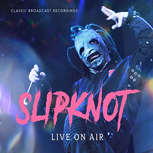 Slipknot band member in mask performing live, album cover art.