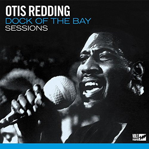Black and white portrait of Otis Redding singing into a microphone.