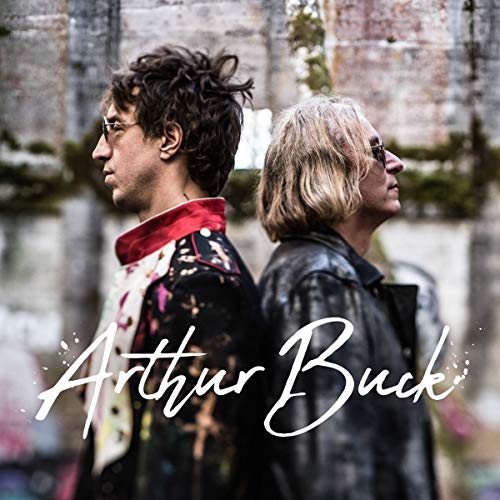 Two men with shoulder-length hair facing away, album title overlaid.