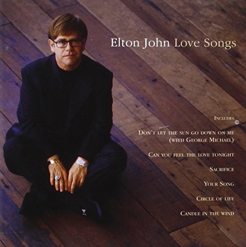 Elton John album cover, “Love Songs”, featuring the artist seated on wood flooring.