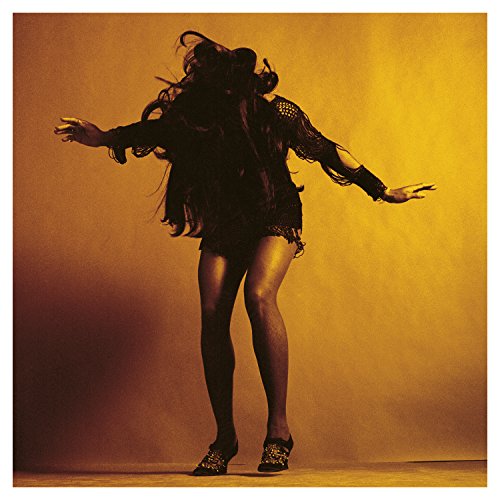Golden album cover featuring a person in a dark, fringed outfit posing.