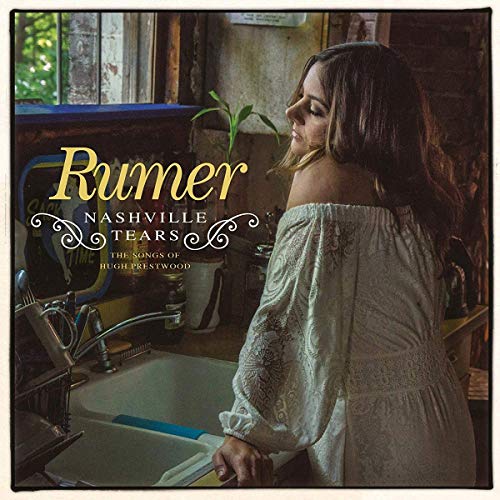 Rumer album cover: woman by a sink, rustic kitchen background.