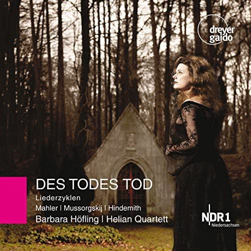 CD cover: woman in black near a small stone chapel in a forest.