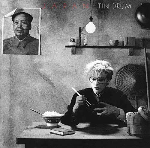 Black and white album cover featuring a boy with chopsticks and Mao portrait.