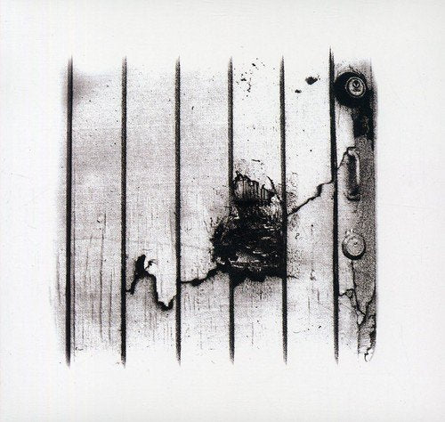 Black and white image of a weathered wooden door with metal hardware.