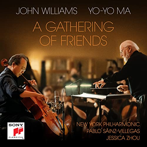 Yo-Yo Ma playing cello with conductor John Williams and orchestra.