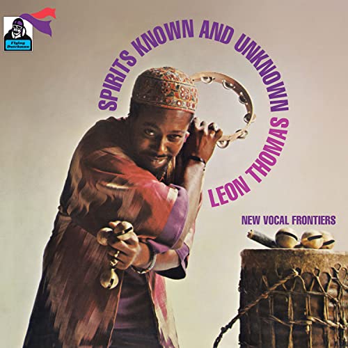 Album cover featuring Leon Thomas with percussion instruments, warm tones.