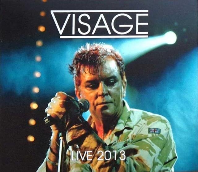 Visage album cover featuring a singer with a microphone on stage.