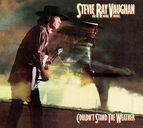 Stevie Ray Vaughan playing guitar, album cover for “Couldn’t Stand The Weather.”