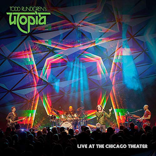 Album cover for Todd Rundgren’s Utopia, live concert scene with band.