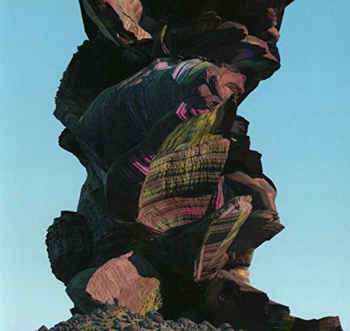 CD cover art: abstract, colorful, layered rock formation against a blue sky.